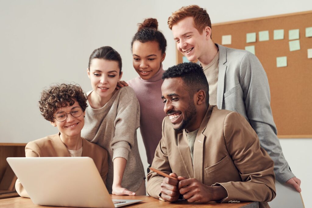 photo of people looking on laptop