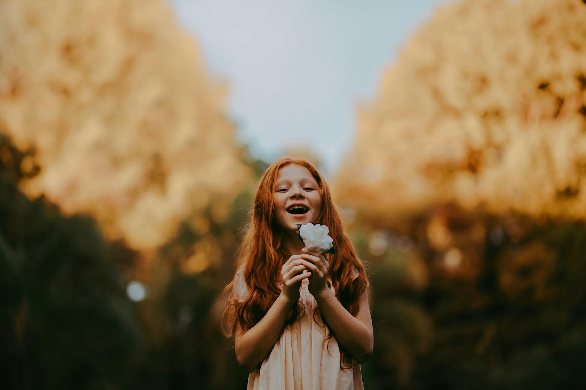 girl holding white flower